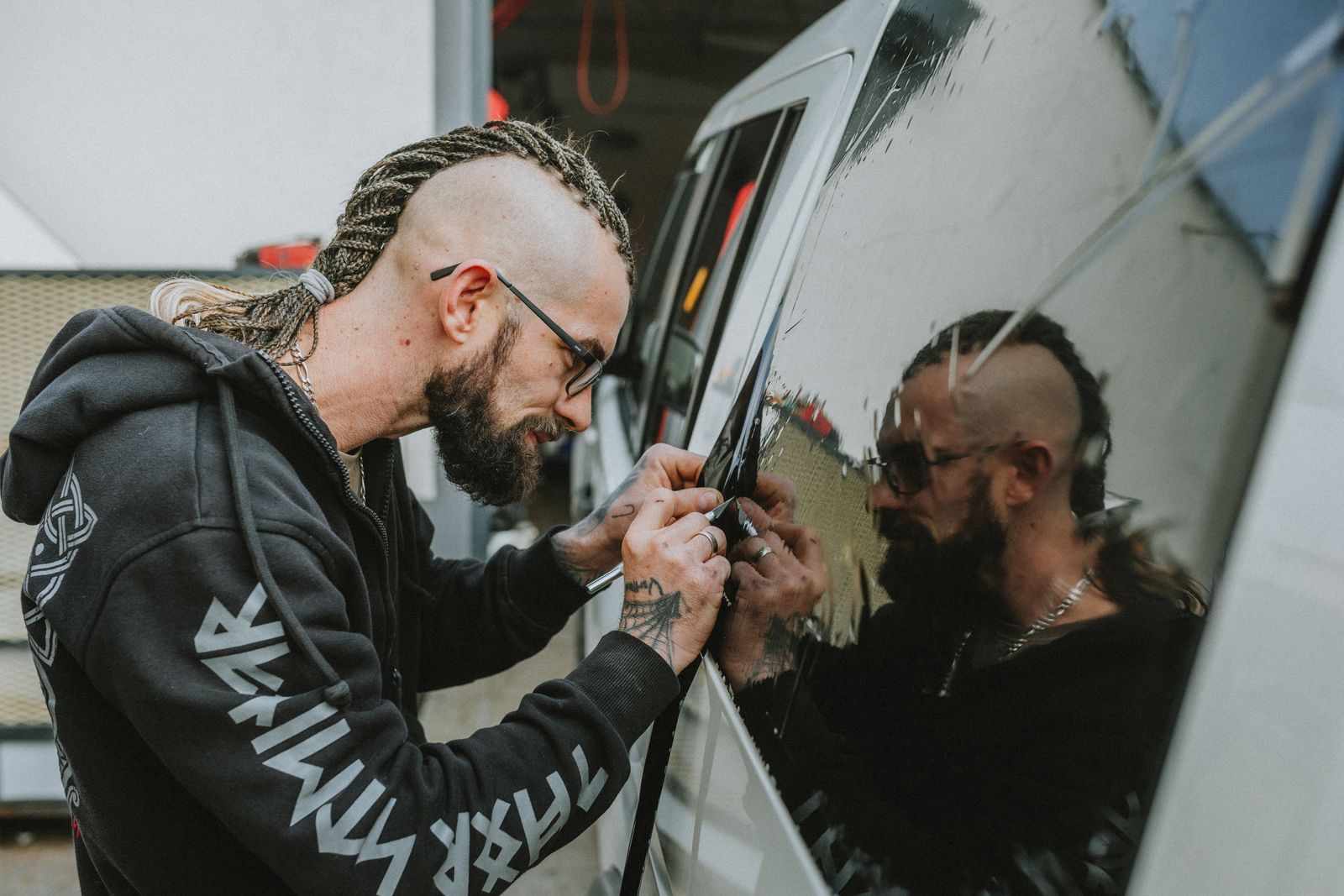 Technician working carefully at an automobile side window